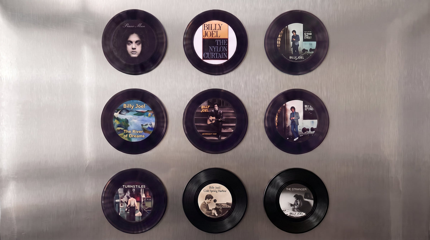 Nine Billy Joel vinyl record magnets on a stainless fridge